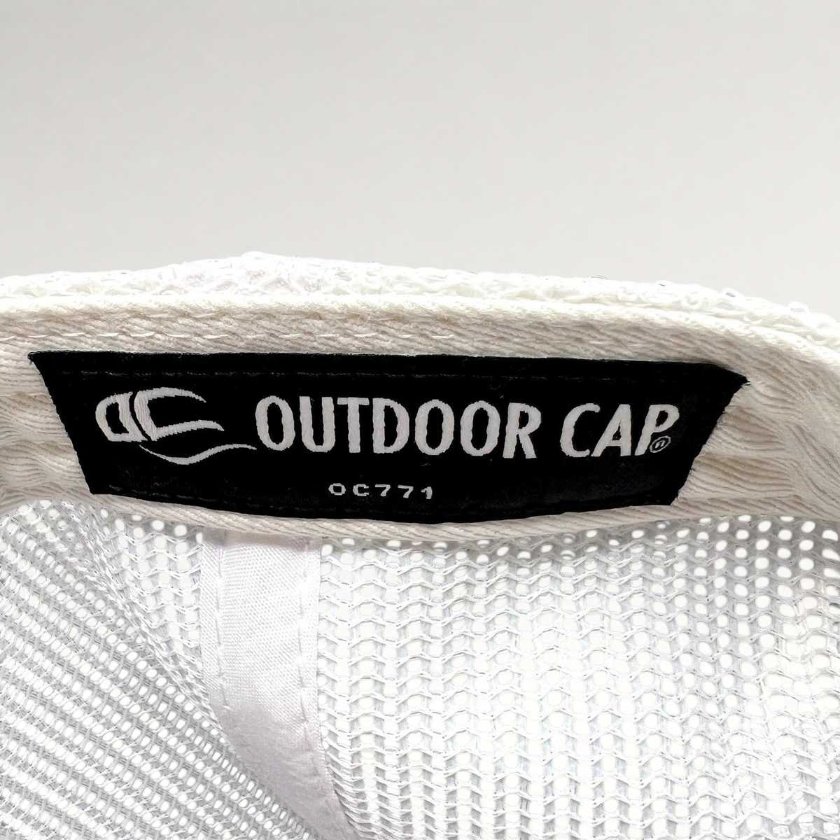 Raree Finds interior label of an Outdoor Cap OC771 trucker hat with white mesh lining