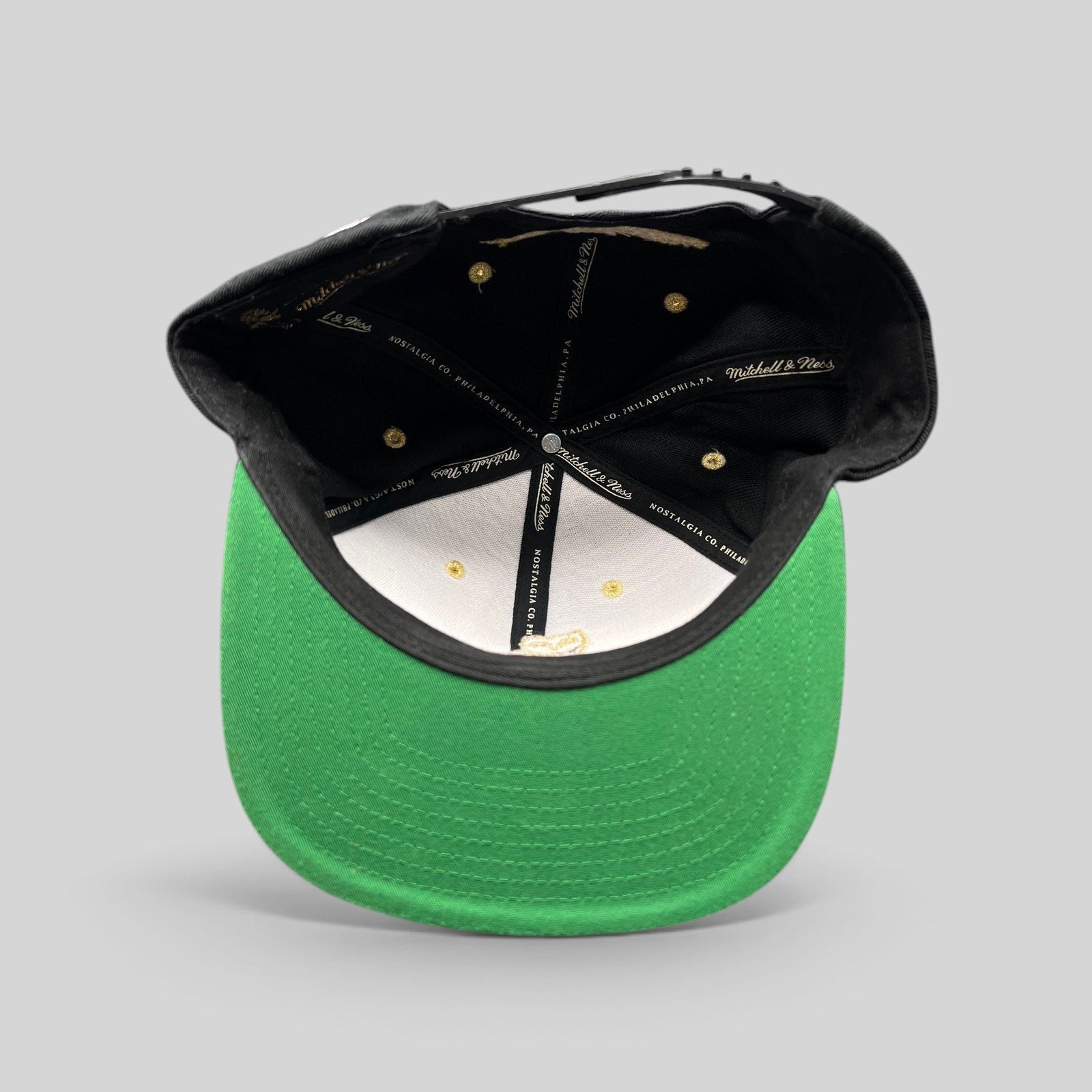 Raree Finds Mitchell & Ness x OVO Toronto Raptors snapback interior showing green underbrim and branded taping