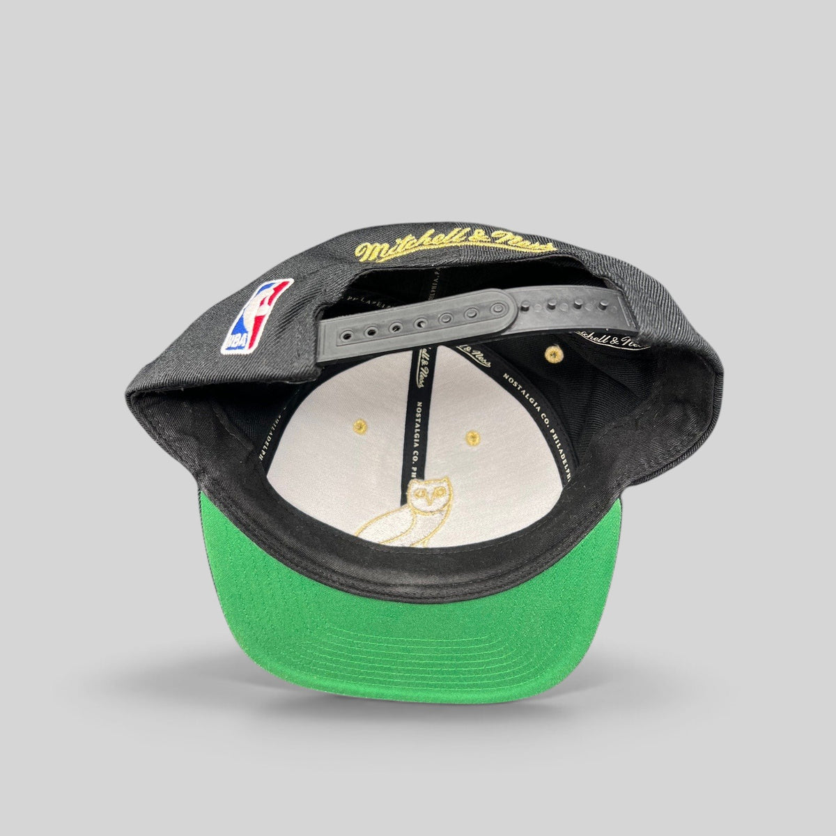 Raree Finds Mitchell & Ness x OVO Toronto Raptors snapback showing the green underbrim, interior owl logo, and NBA patch