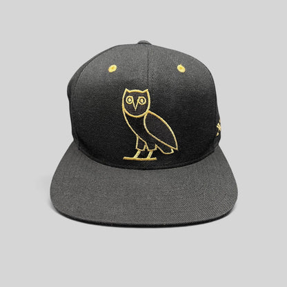 Raree Finds black and gold OVO owl snapback hat from the 2015 Mitchell & Ness Toronto Raptors collaboration