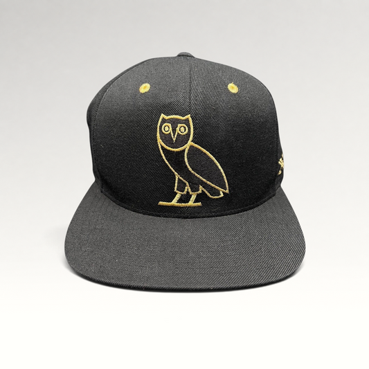 Raree Finds black and gold OVO owl snapback hat from the 2015 Mitchell & Ness Toronto Raptors collaboration
