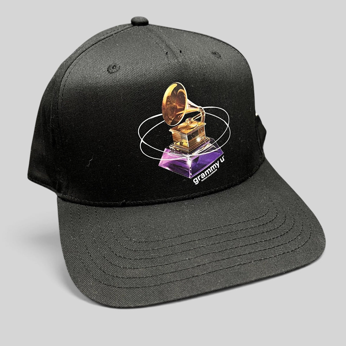 Raree Finds black PacSun Grammy U snapback hat with a gold gramophone graphic and orbital design on the front panel.
