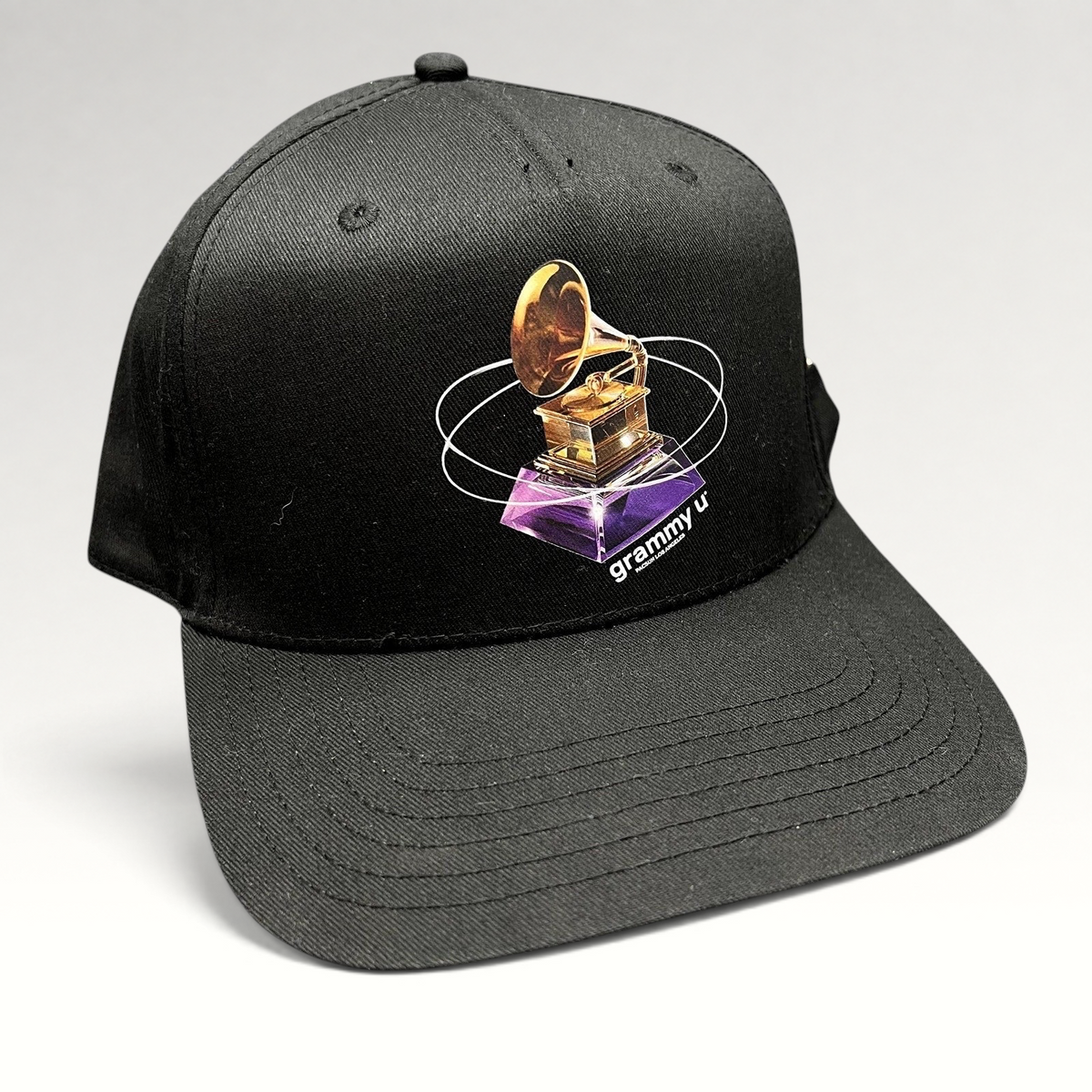 Raree Finds black PacSun Grammy U snapback hat with a gold gramophone graphic and orbital design on the front panel.