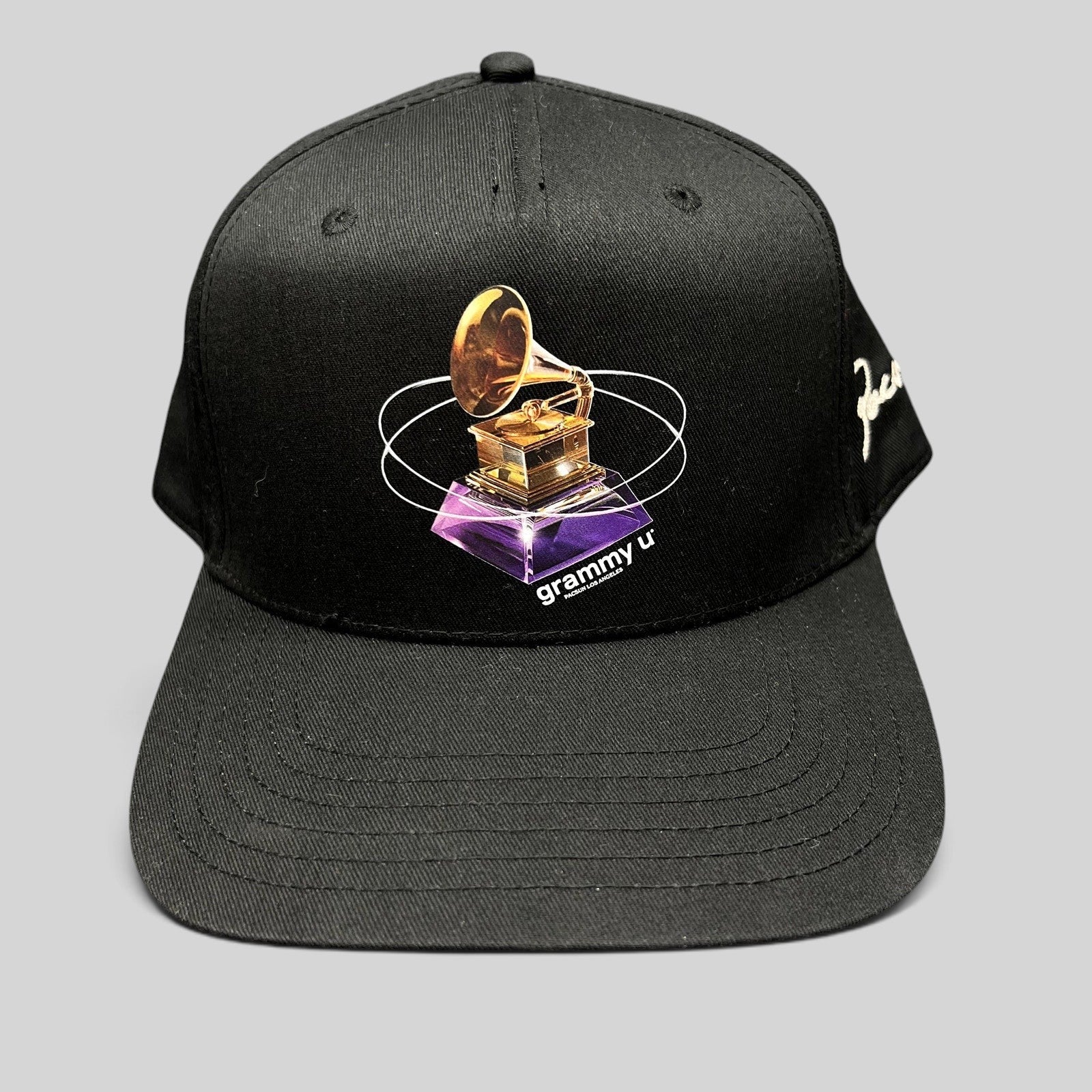 Raree Finds black PacSun Grammy U snapback hat featuring a gold gramophone graphic and side embroidery on a flat bill.