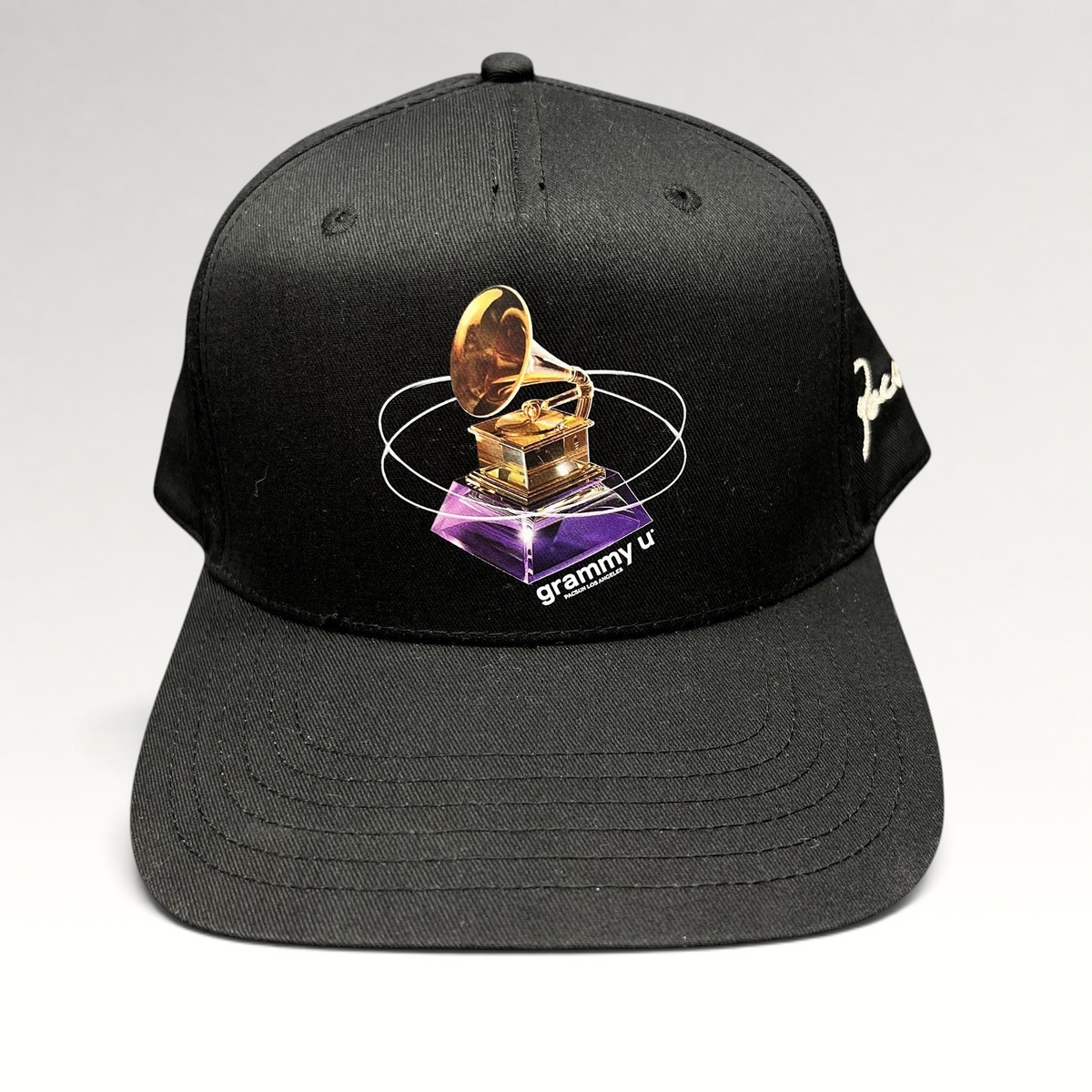Raree Finds black PacSun Grammy U snapback hat featuring a gold gramophone graphic and side embroidery on a flat bill.