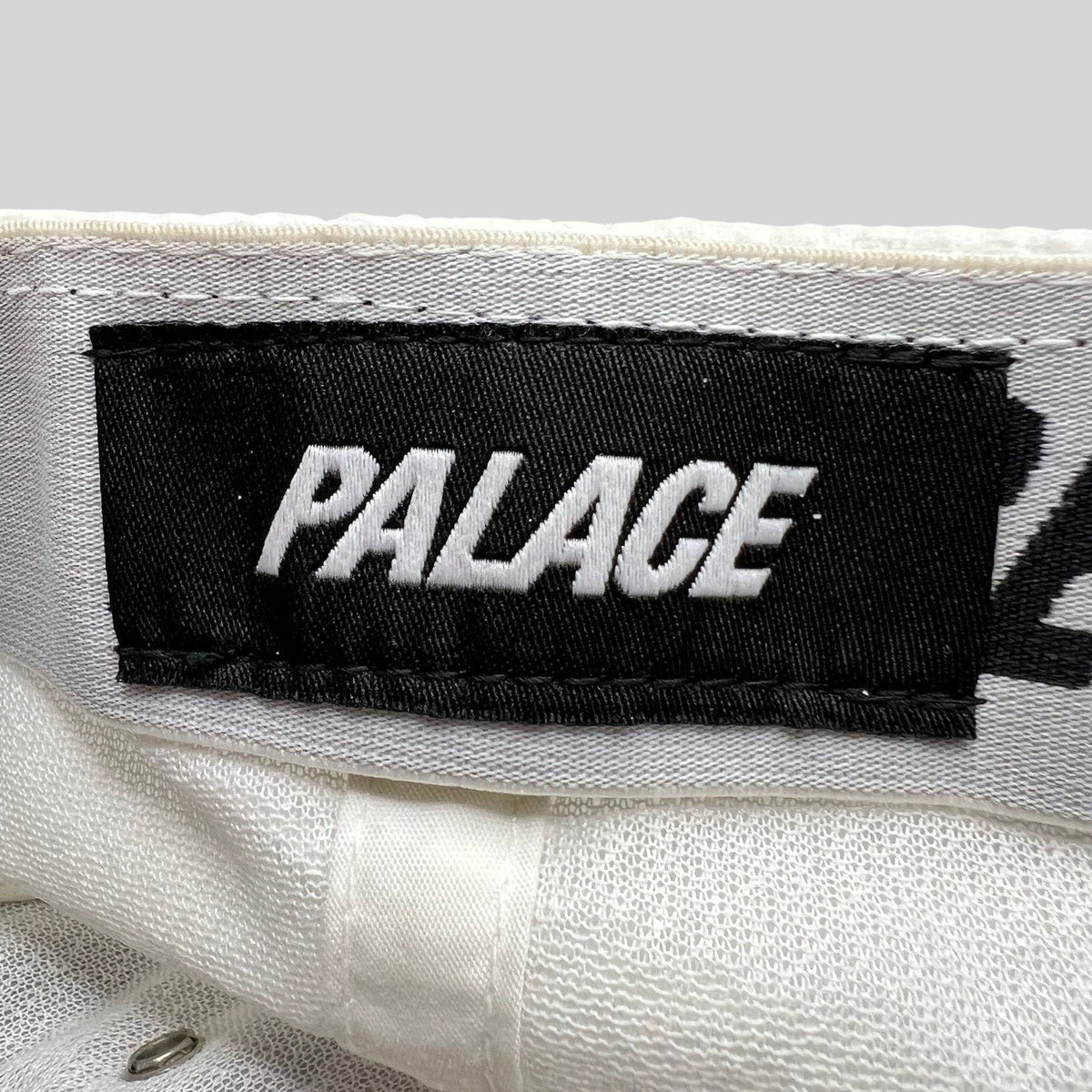 Raree Finds white Palace Skateboards hat interior label with black and white embroidered branding