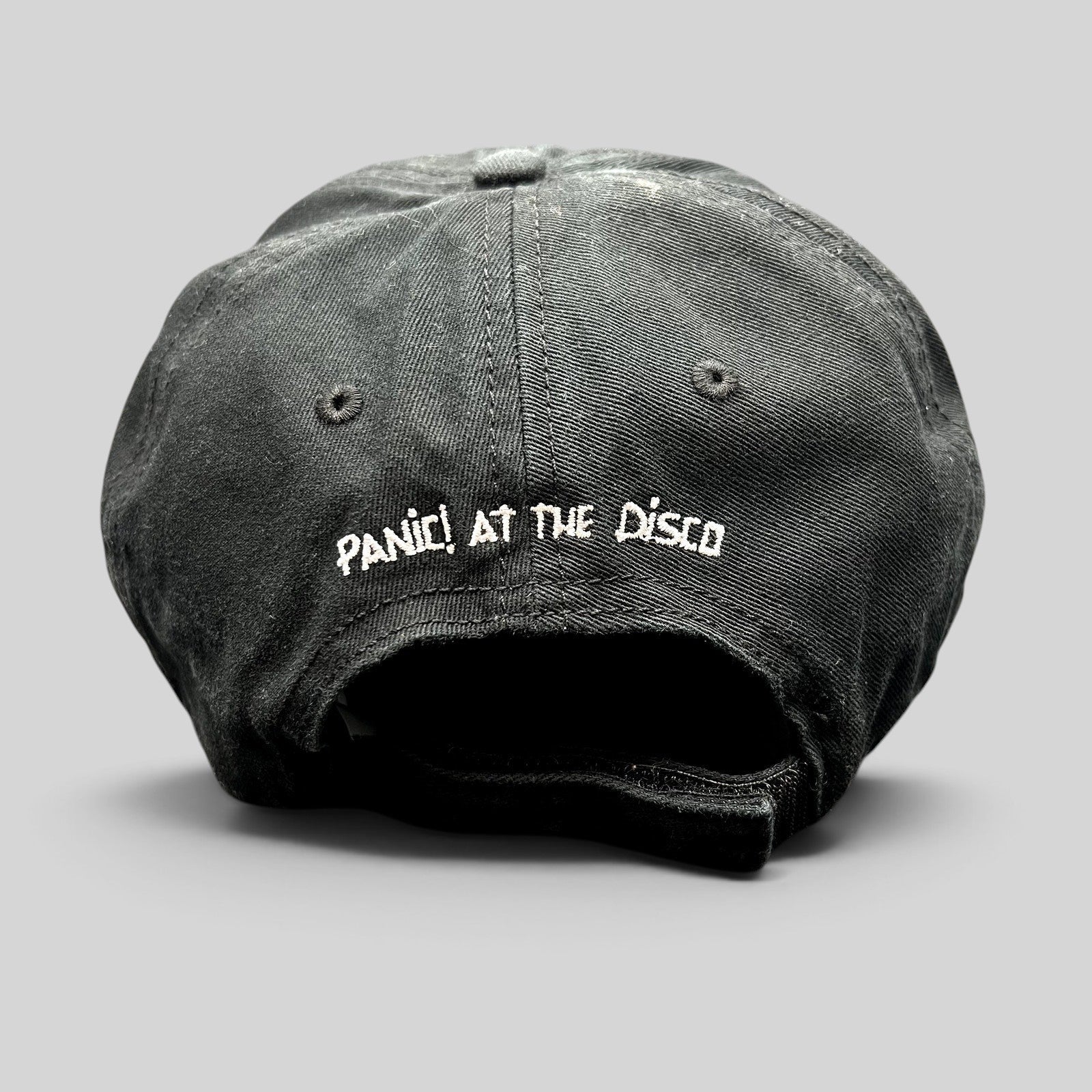 Raree Finds black cotton strapback hat with white Panic! At The Disco logo embroidery on the back