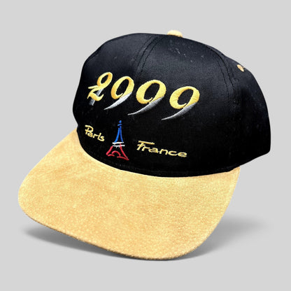 Raree Finds vintage Y2K Paris France snapback hat with black crown, tan suede brim, and Eiffel Tower embroidery.
