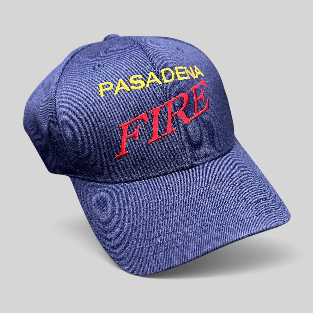 Raree Finds navy blue Yupoong Flexfit hat with Pasadena Fire embroidered in red and yellow on the front crown