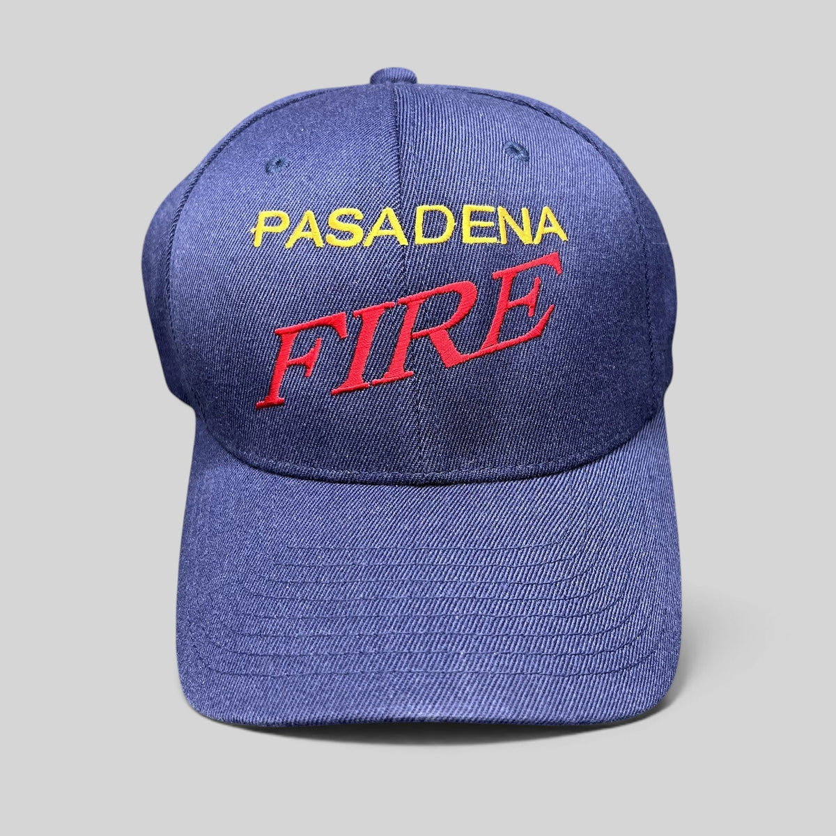 Raree Finds navy blue Yupoong Flexfit hat with embroidered Pasadena Fire lettering in red and yellow on the crown