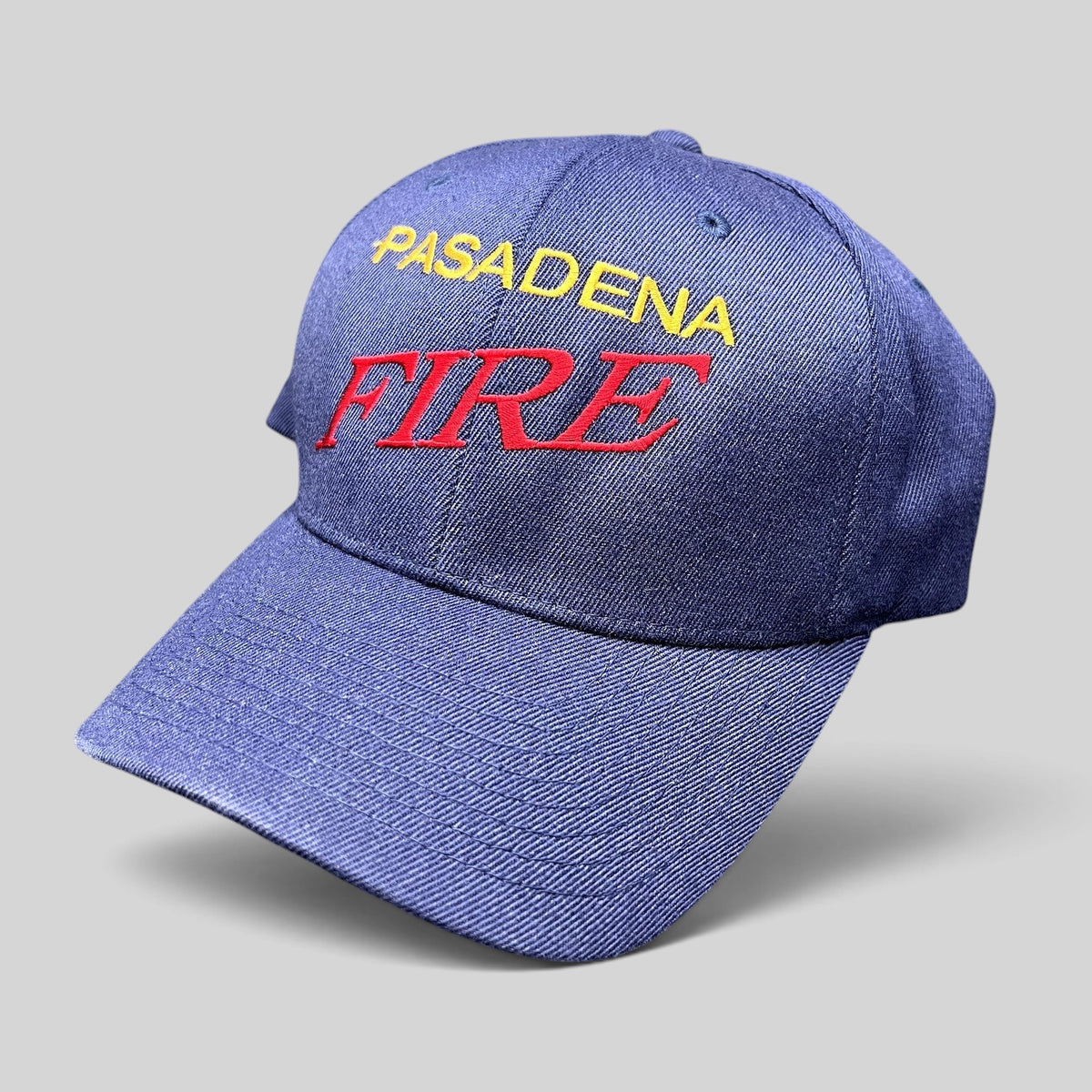 Raree Finds navy blue Yupoong Flexfit hat with embroidered Pasadena Fire lettering in red and yellow on the crown.