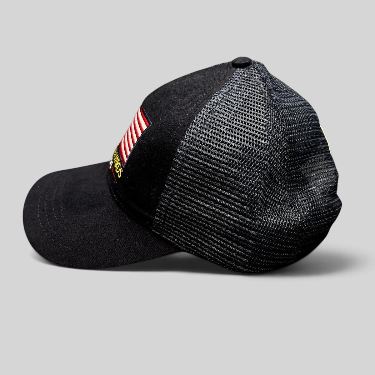 Raree Finds Patriot Awards 2021 navy and black trucker hat with embroidered American flag and mesh back side view