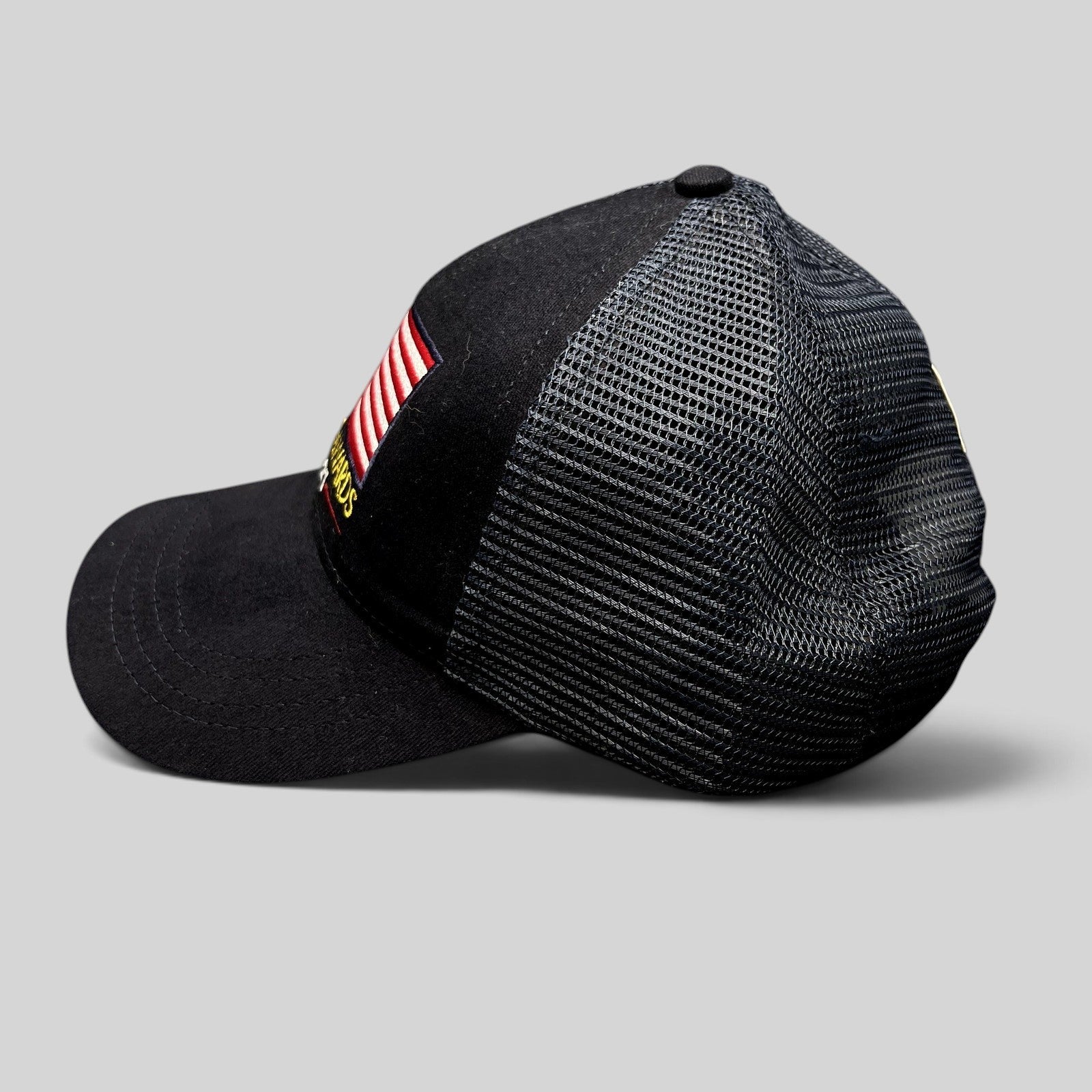 Raree Finds Patriot Awards 2021 navy and black trucker hat with embroidered American flag and mesh back side view