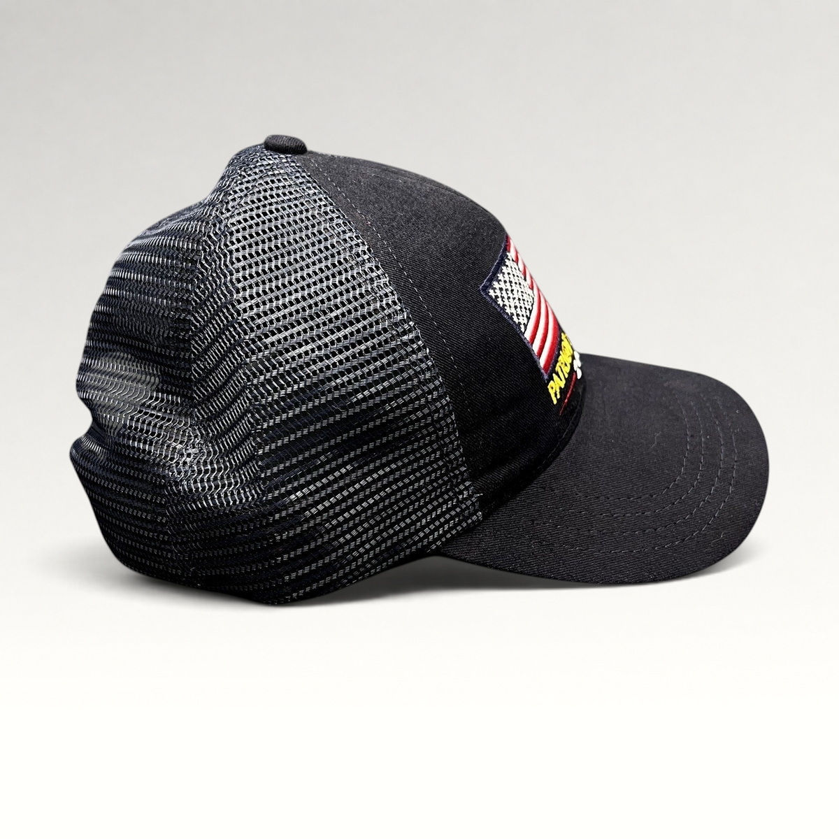 Raree Finds Patriot Awards 2021 navy and black trucker hat with an embroidered American flag and mesh back