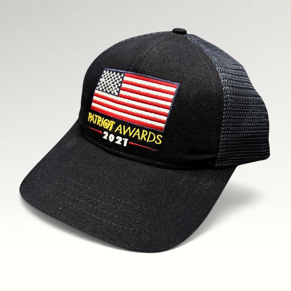 Raree Finds navy and black Patriot Awards 2021 trucker hat with an embroidered American flag and adjustable snapback