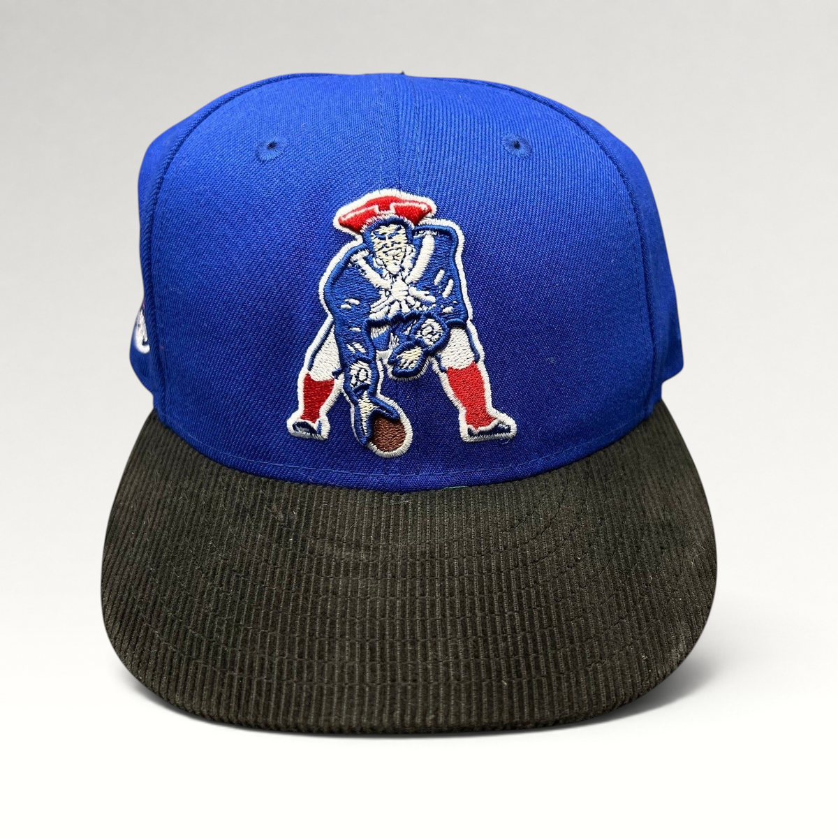 Raree Finds New Era 59FIFTY New England Patriots fitted hat with a royal blue crown and black corduroy brim.