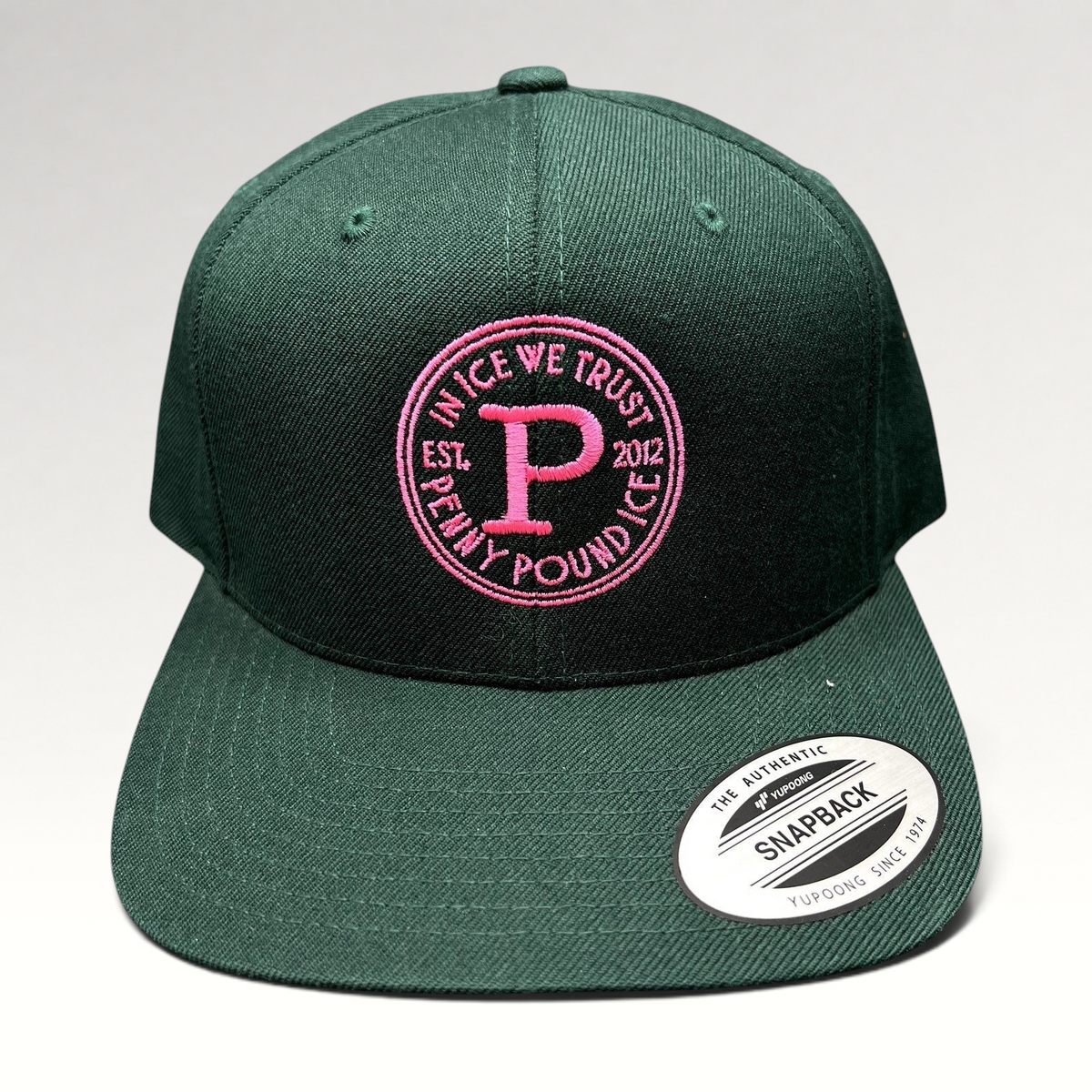 Raree Finds Penny Pound Ice dark green snapback hat with bright pink In Ice We Trust circular logo embroidery