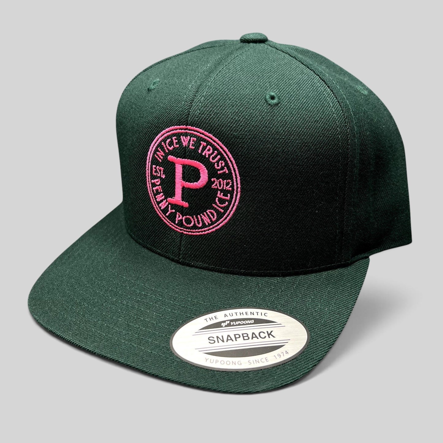 Raree Finds Penny Pound Ice dark green snapback hat with pink In Ice We Trust circular embroidery on structured crown