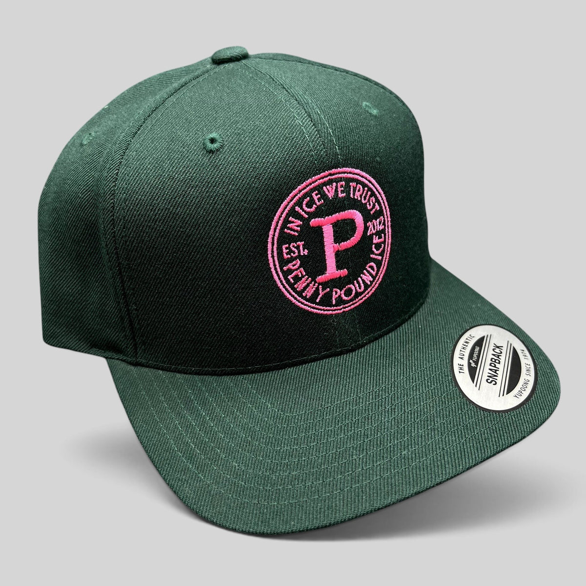 Raree Finds Penny Pound Ice dark green snapback hat with pink In Ice We Trust circular logo embroidery