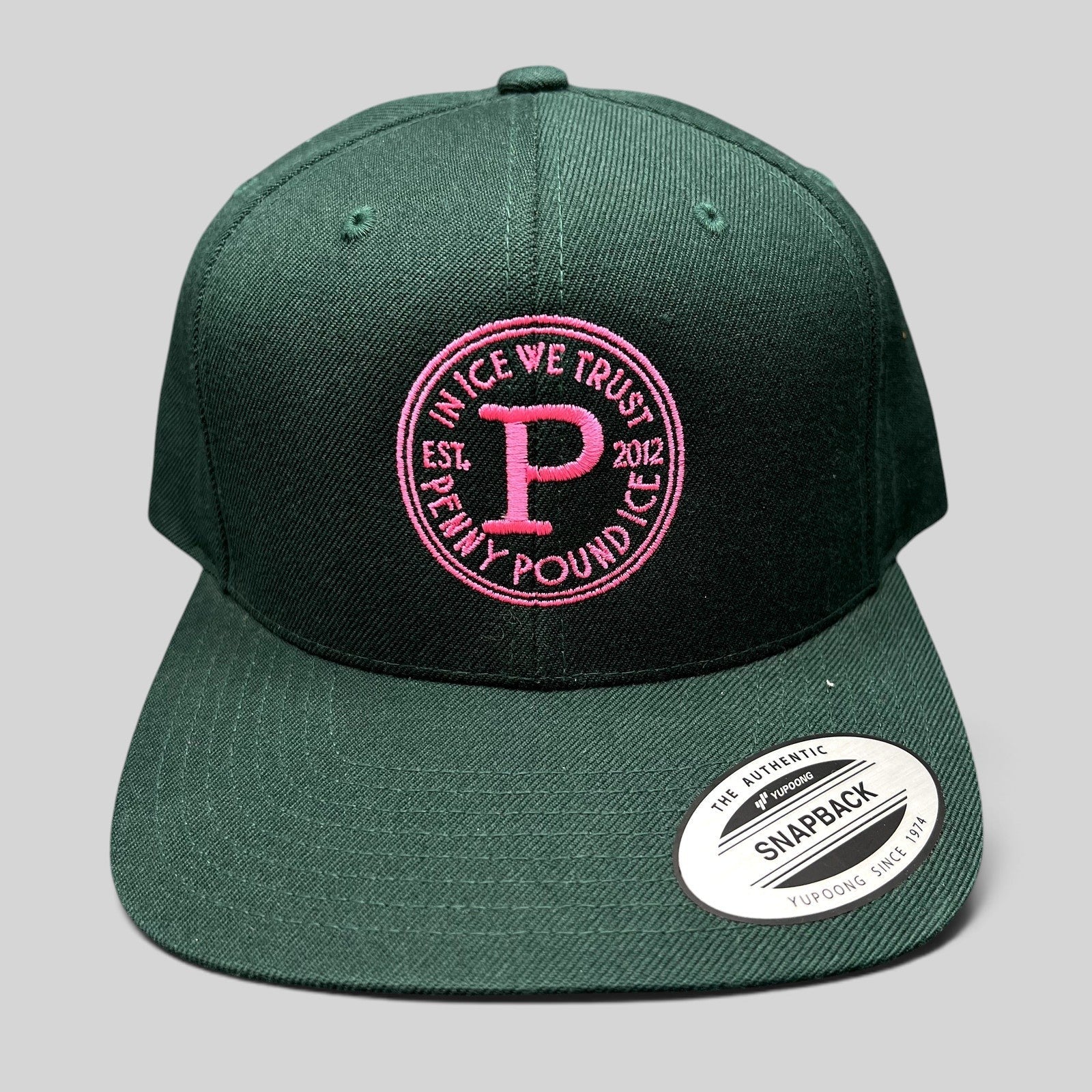 Raree Finds Penny Pound Ice dark green snapback hat with pink In Ice We Trust circular logo embroidery