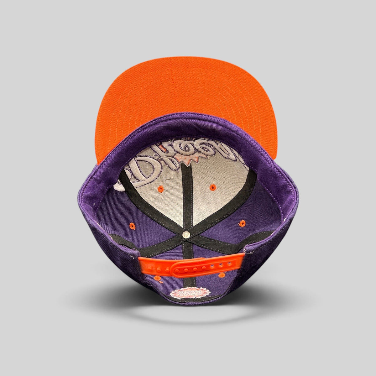 Raree Finds Phoenix Suns Hardwood Classics snapback hat showing the interior purple crown and orange flat brim