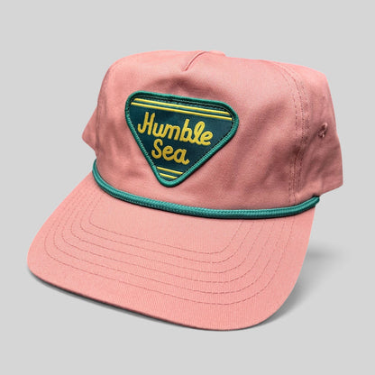 Raree Finds pink cotton strapback hat with a teal and yellow Humble Sea Brewing patch and teal rope brim detail.