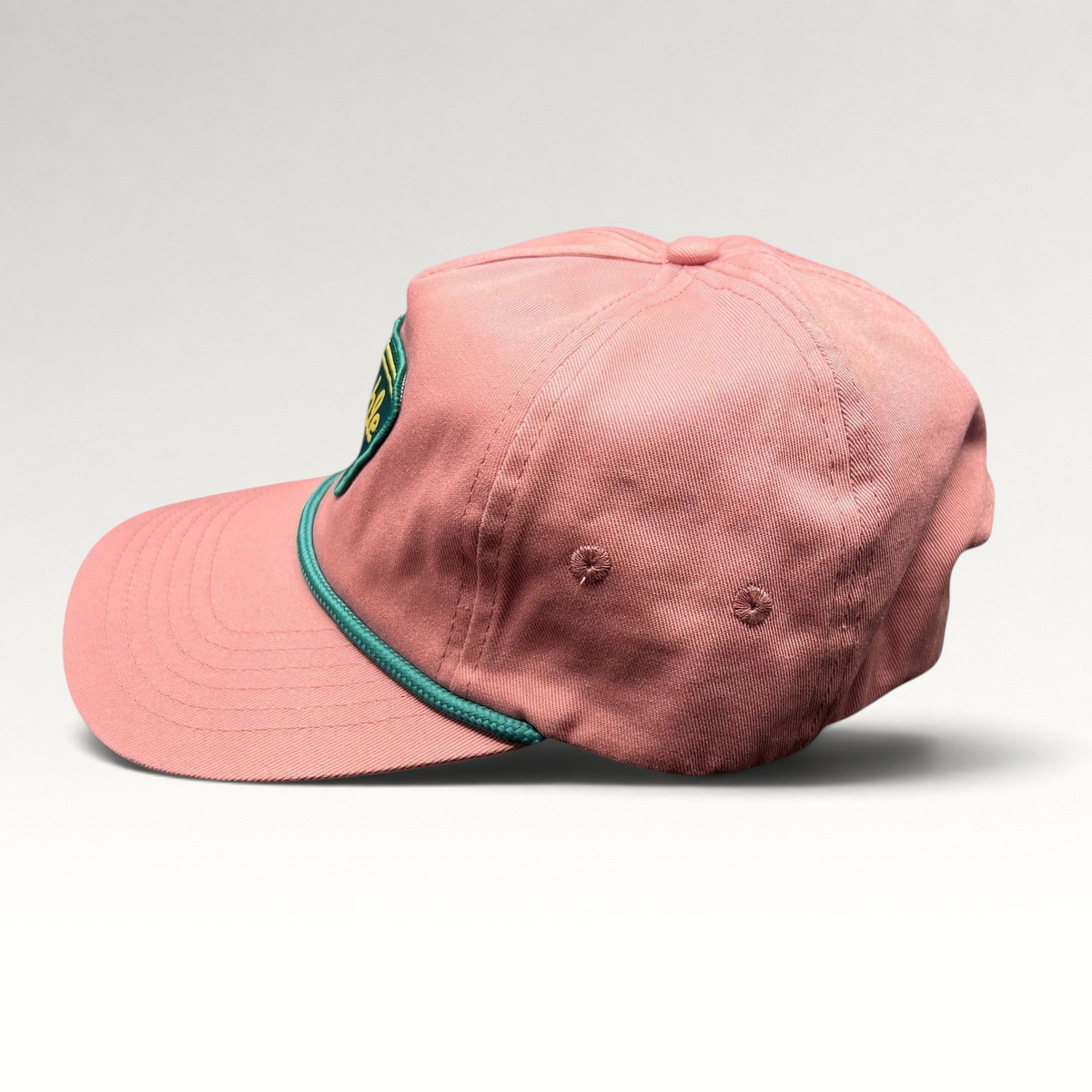 Raree Finds pink strapback hat with teal rope detail and Humble Sea Brewing patch, side profile view.