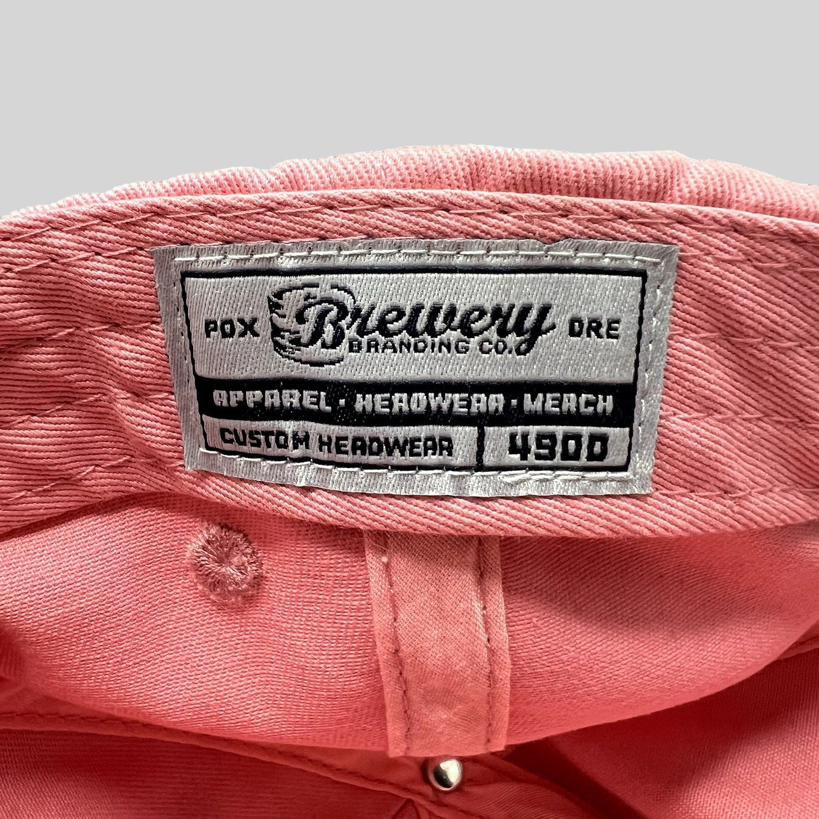 Raree Finds pink cotton strapback hat interior featuring a Brewery Branding Co woven label on the crown
