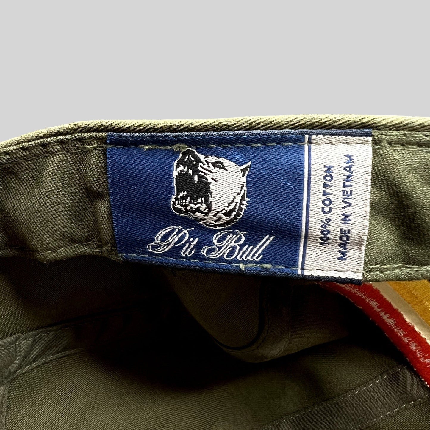 Raree Finds Pit Bull Headwear brand label inside an olive green cotton 5 panel hat