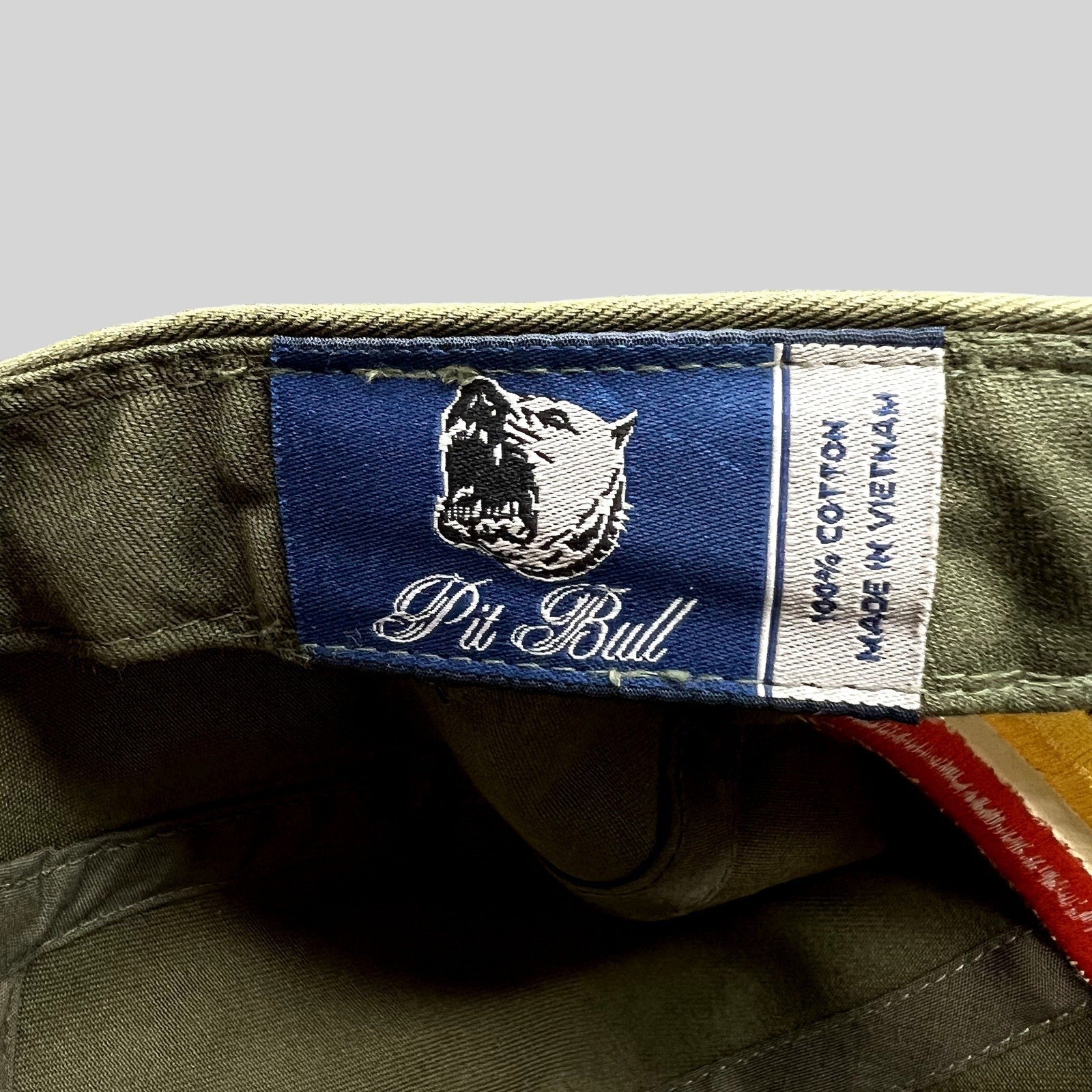 Raree Finds Pit Bull Headwear brand label inside an olive green cotton 5 panel hat