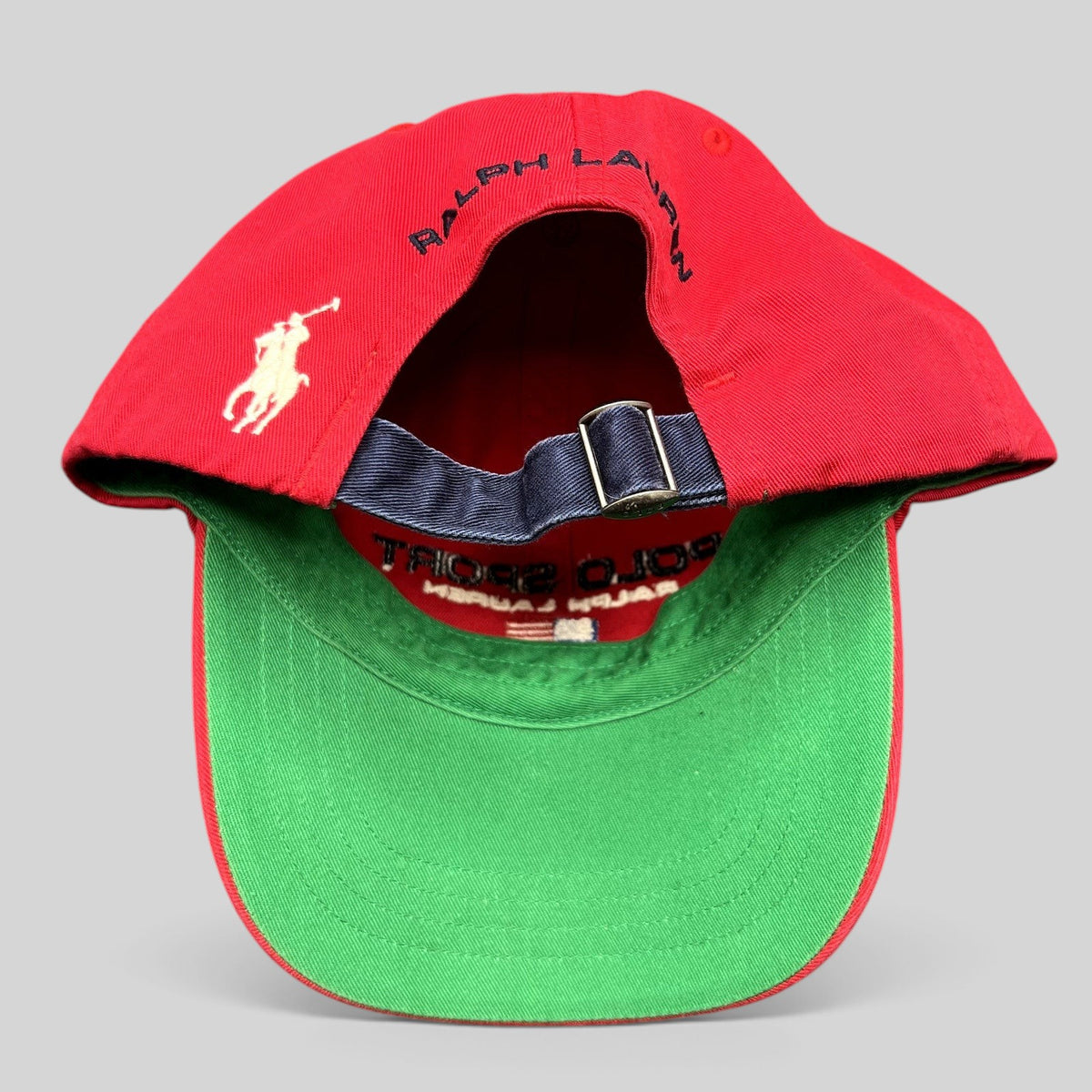 Raree Finds vintage red Polo Sport Ralph Lauren strapback cap with green undervisor and rear embroidered pony logo