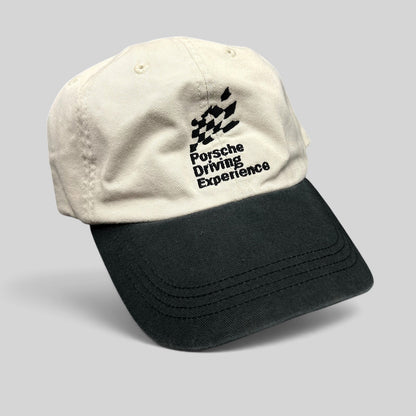Raree Finds Porsche Driving Experience strapback hat in black and cream with embroidered logo and unstructured fit.