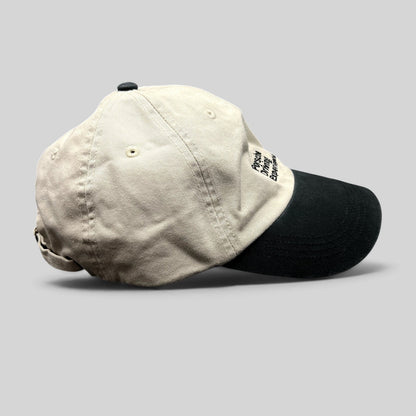 Raree Finds Porsche Driving Experience strapback hat in black and cream with embroidered logo and brass hardware.