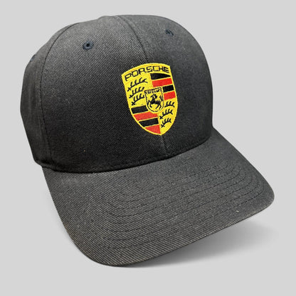 Raree Finds black Porsche Woodland Hills Flexfit cap with an embroidered Porsche crest logo on the front crown.