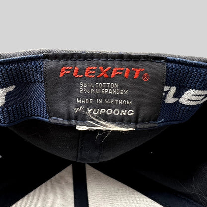 Raree Finds Porsche Woodland Hills hat interior tag showing Yupoong Flexfit branding and cotton spandex material