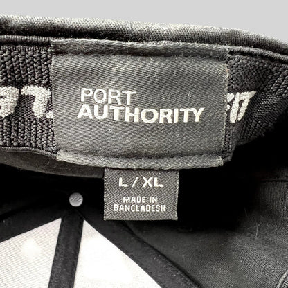 Raree Finds Port Authority black flexfit cap interior label showing L/XL size and Bangladesh manufacturing details
