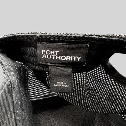 Raree Finds Port Authority trucker hat interior label showing brand name and Made in Bangladesh origin