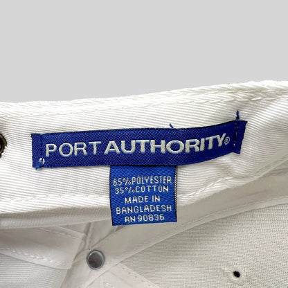 Raree Finds white Port Authority hat interior label showing 65 percent polyester and 35 percent cotton material blend