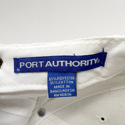 Raree Finds white Port Authority hat interior label showing 65 percent polyester and 35 percent cotton material blend