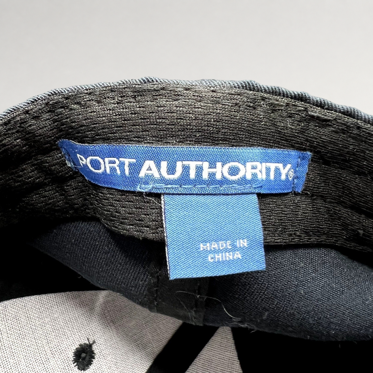 Raree Finds vintage Port Authority hat interior label showing blue brand tag and Made in China origin tag