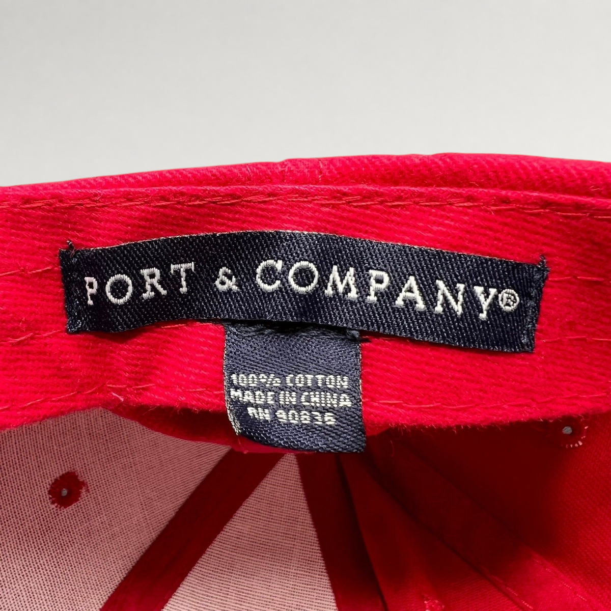 Raree Finds Port & Company brand label inside a red cotton hat from the 2010 Little Fockers movie promotion.