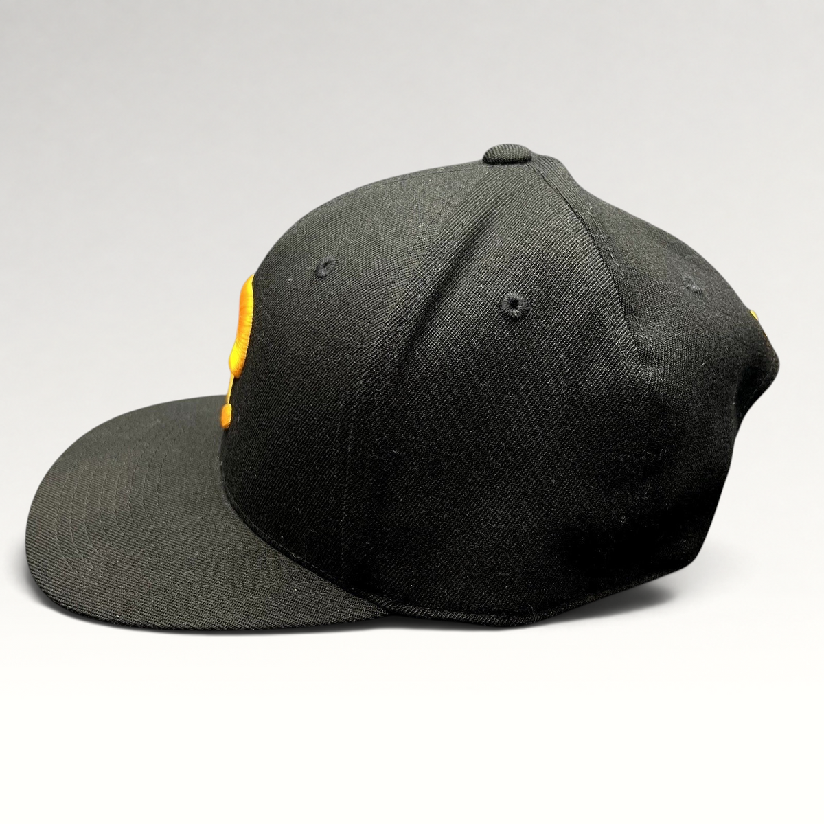Raree Finds Postino restaurant snapback hat in black with a gold embroidered P logo on a structured Yupoong 110 cap.