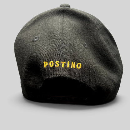 Raree Finds black snapback hat with yellow POSTINO embroidery on the back, featuring a structured Yupoong 110 design.
