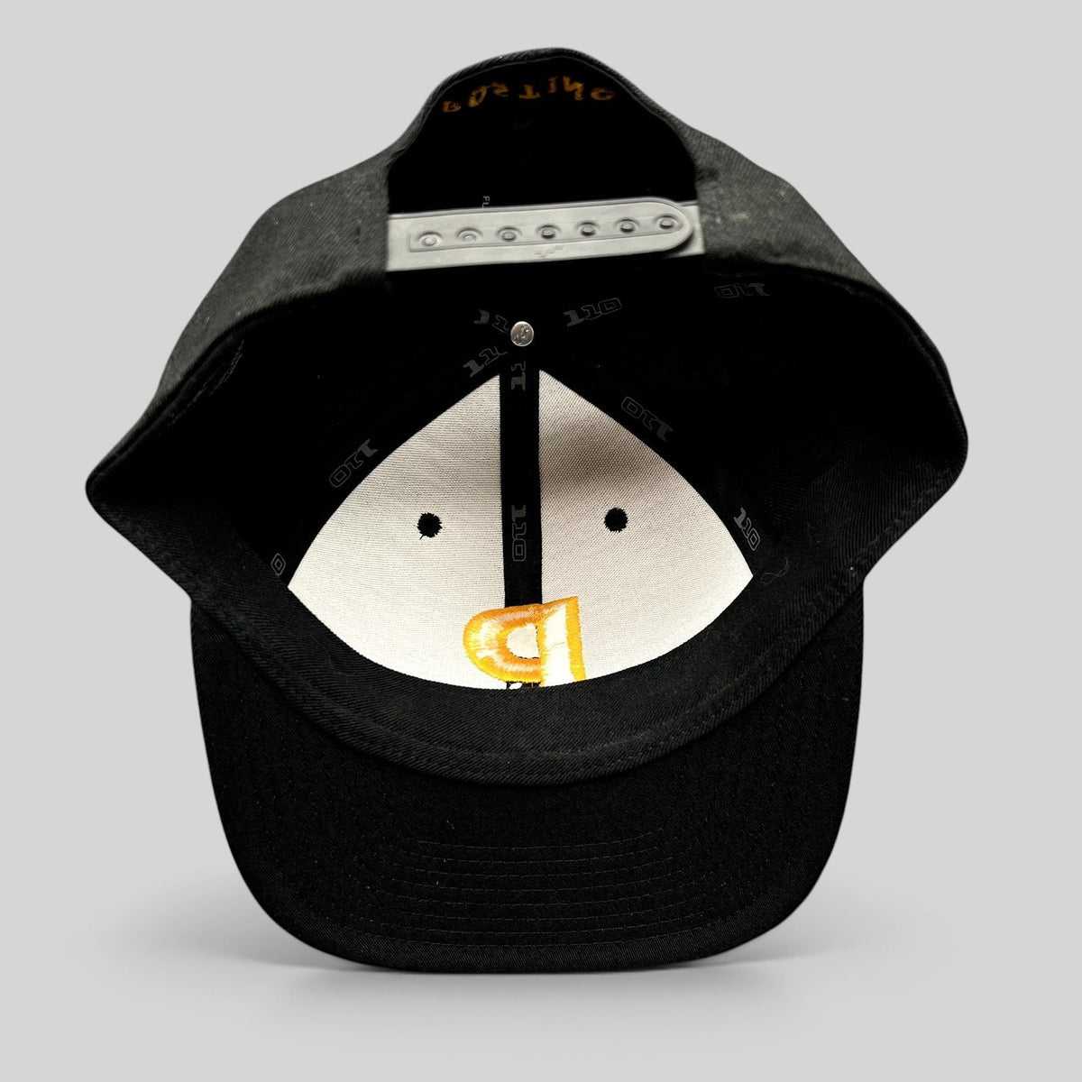 Raree Finds Postino restaurant snapback hat interior view showing Yupoong 110 Flexfit branding and adjustable closure.