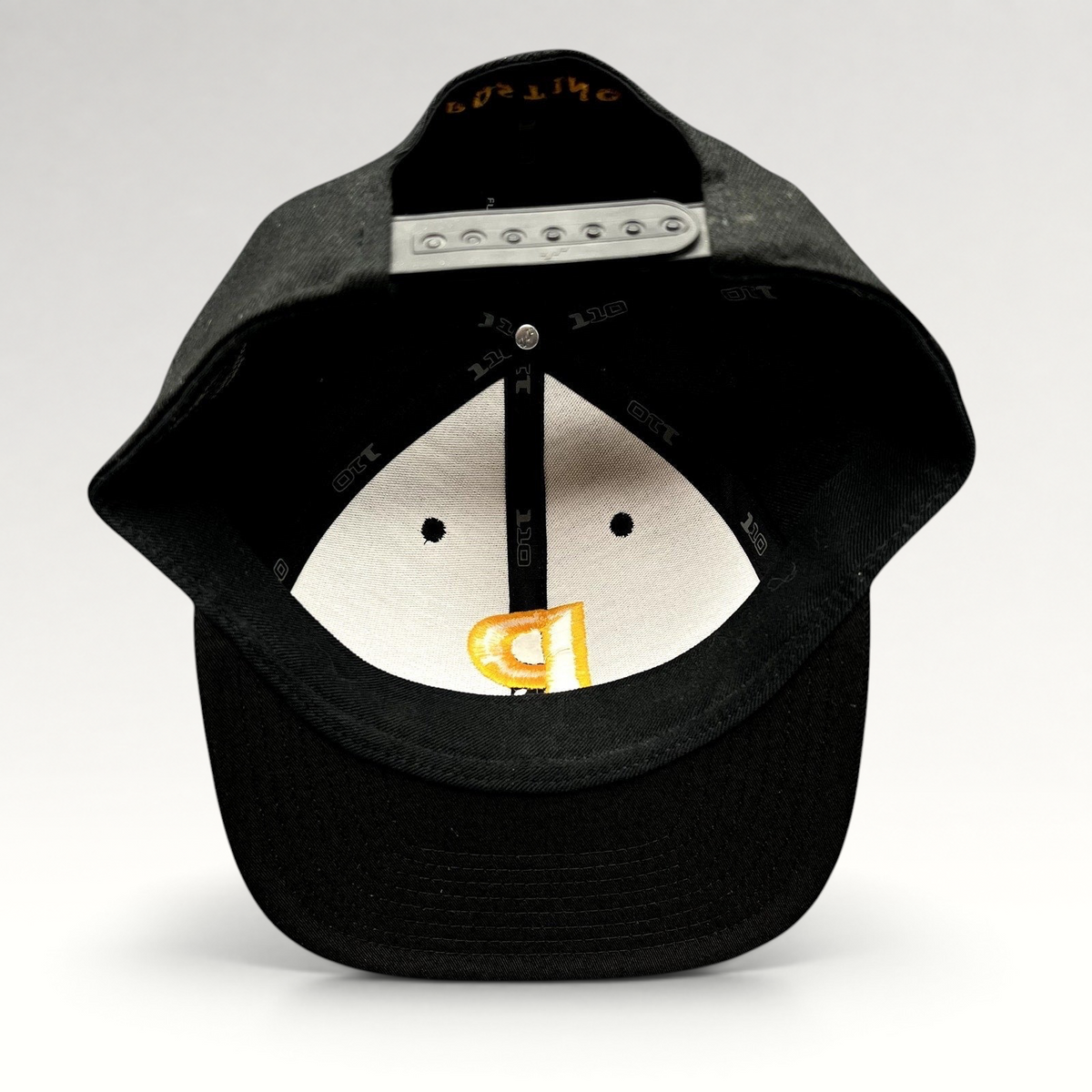Raree Finds Postino restaurant snapback hat interior view showing Yupoong 110 Flexfit branding and adjustable closure.