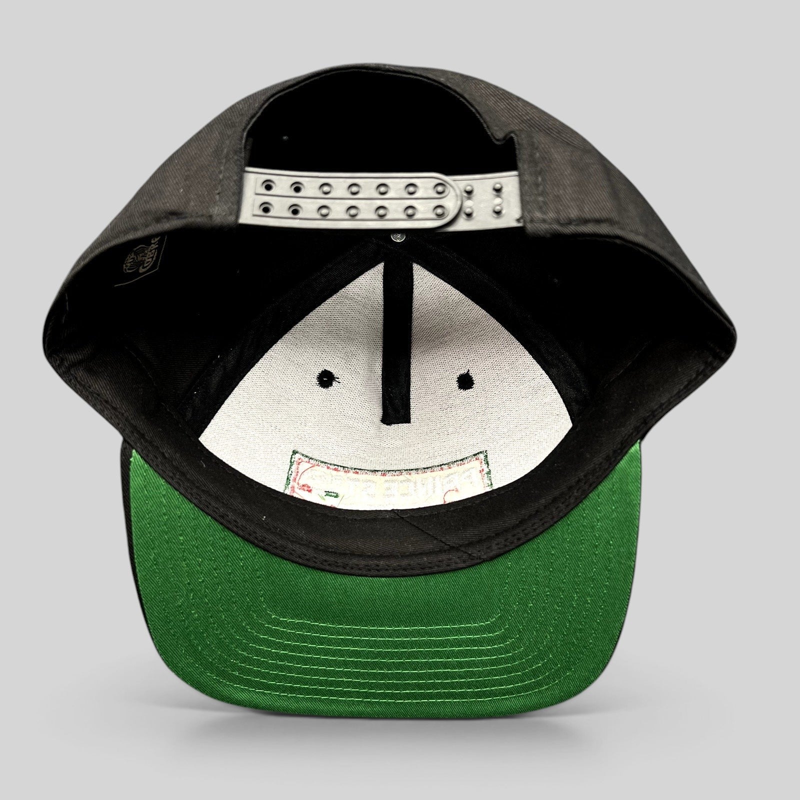 Raree Finds Prince St Pizza Los Angeles black snapback hat with green undervisor and adjustable plastic closure