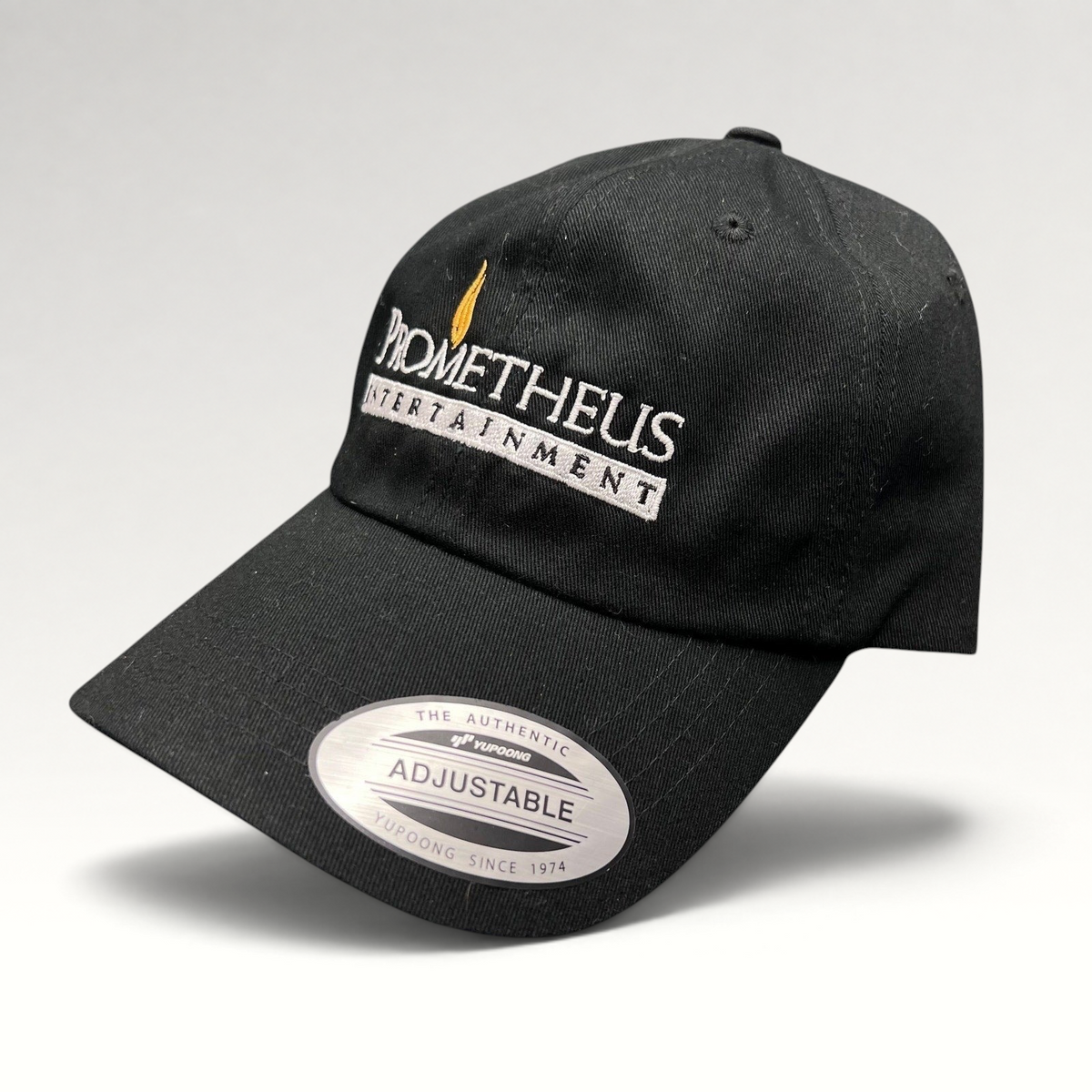 Raree Finds black Yupoong strapback hat with white and orange Prometheus Entertainment logo embroidery