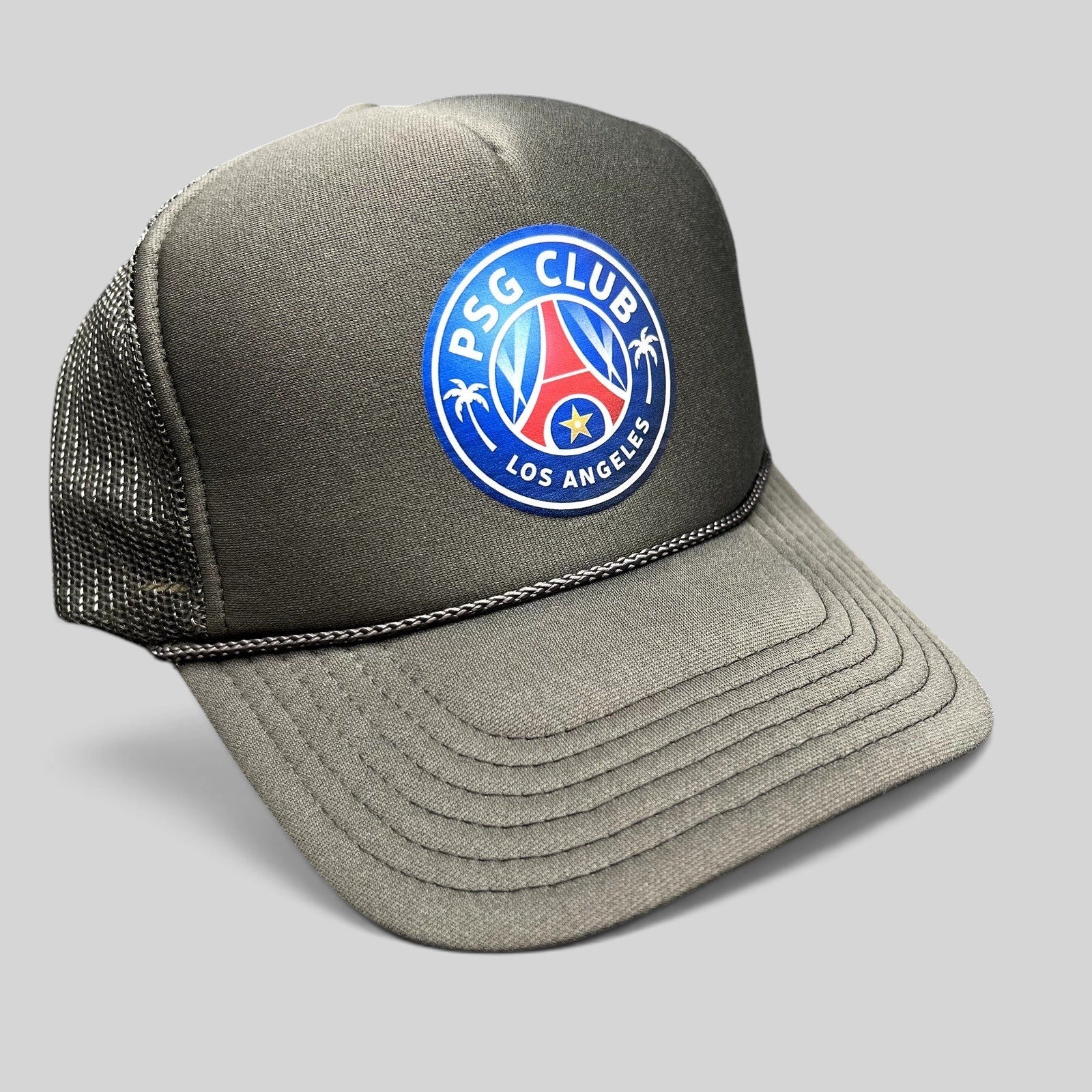 Raree Finds PSG Club Los Angeles charcoal gray and black mesh trucker hat with a soccer-inspired crest graphic.