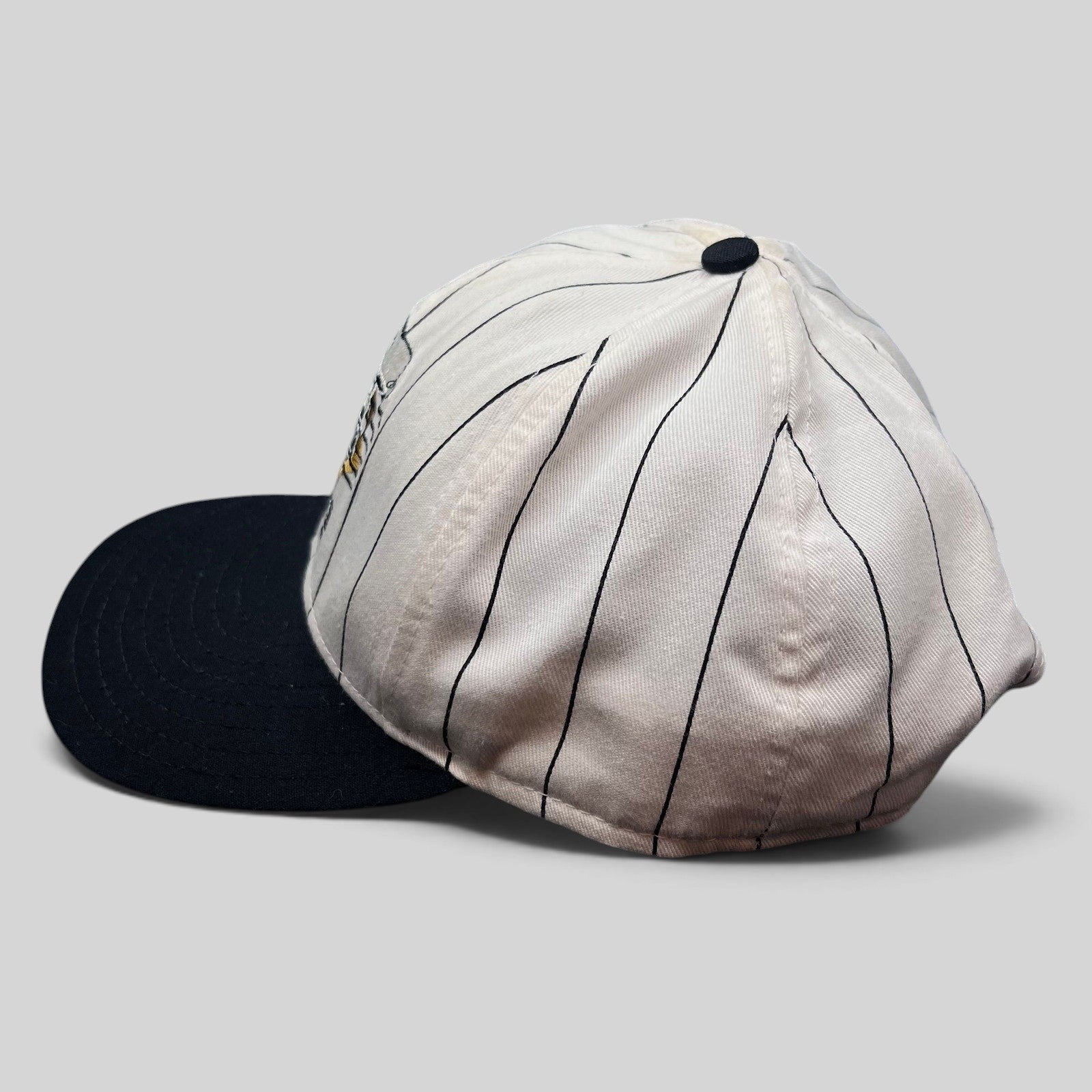 Raree Finds vintage Purdue Boilermakers snapback hat with white pinstripe crown and black brim, side profile view.