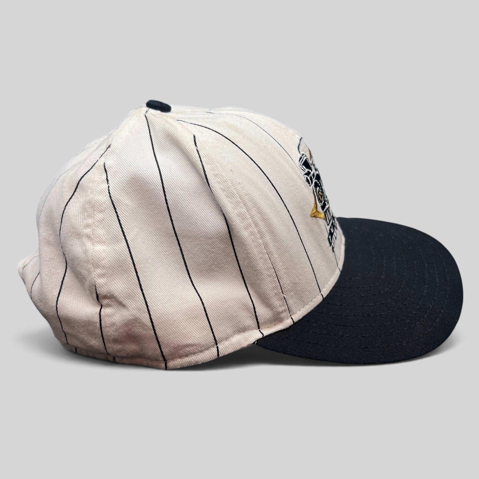 Raree Finds vintage Purdue Boilermakers snapback hat with white pinstripe crown, black bill, and embroidered logo.